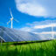 Solar energy panels and windmills against blue sky on summer day, background