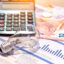 Electricity bill next to a calculator, a bulb and money. Electricity price concept.